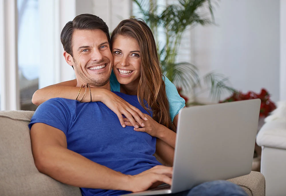 Young couple using their laptop to request a loan from NextStopLoans.com
